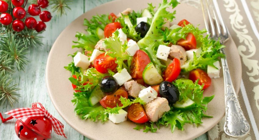 Fresh salad with tuna, tomatoes and cucumbers on lettuce leaves